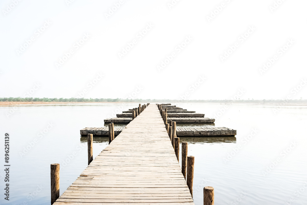 Fototapeta premium Wooden path leading to the horizon
