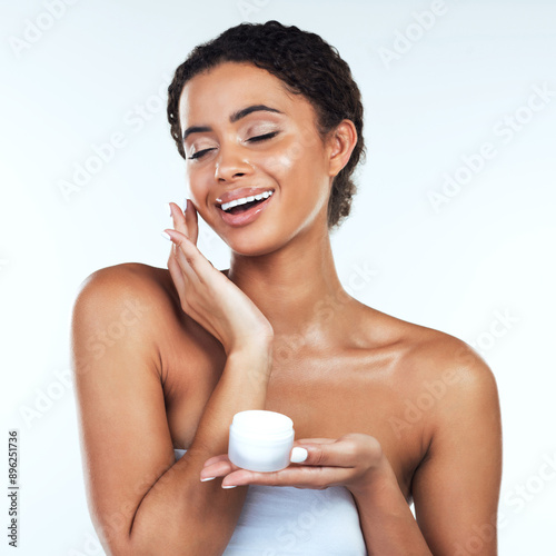 Cream, skincare and woman with eyes closed in studio for facial treatment, cosmetics or dermatology with white background. Wellness, beauty and model with product for moisturizer, shine or glow