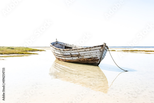 Abandoned Wooden Boat in Shallow Water photo