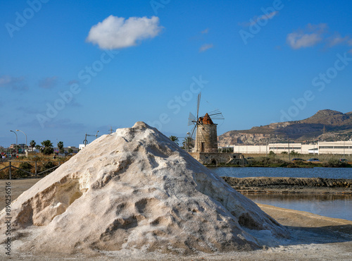 Historical salt flats in Trapani. The salt culture extraction and production in this city represents one of the major economic revenue and it is one of the oldest traditions photo