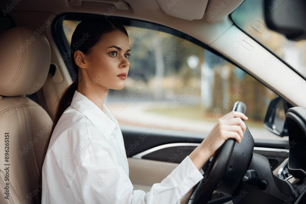 female driver with hands on steering wheel, smiling and looking at the camera inside a car, daytime setting, showing confidence and focus on the road female driver with hands on steering wheel, smiling and looking at the camera inside a car, daytime setting, showing confidence and focus on the road