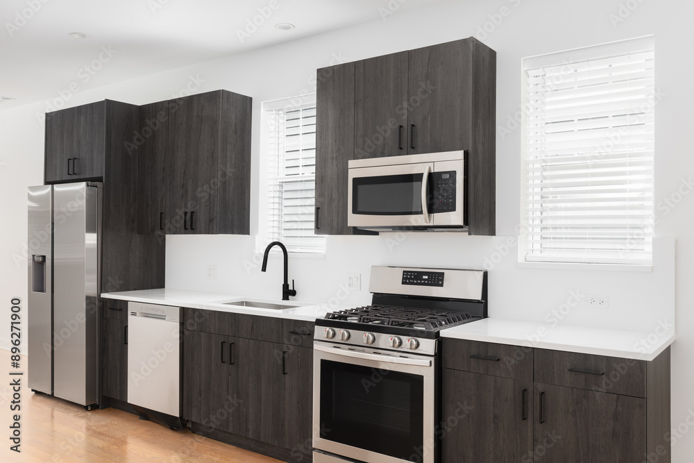 A modern bathroom with dark wood cabinets, white quartz countertops, stainless steel appliances, and hardwood flooring. No brands or labels. A modern bathroom with dark wood cabinets, white quartz countertops, stainless steel appliances, and hardwood flooring. No brands or labels.