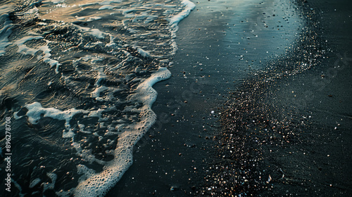 A beach with dark and light-colored sand.
