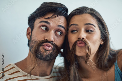 Couple, home and hair mustache with pout, fun and kissing face with meme, bonding and love together. Young man, woman and silly romance for relaxing smile with care, happiness and comic joke