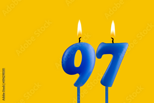 Blue candle number 97 - Birthday on yellow background