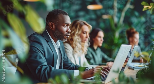 Smiling Coworkers Using Laptops