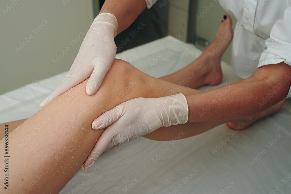 A woman gets a foot massage in a beauty salon. A woman gets a foot massage in a beauty salon.