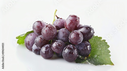 A bunch of ripe juicy purple grapes with water drops on the surface and green leaf isolated on white background. photo