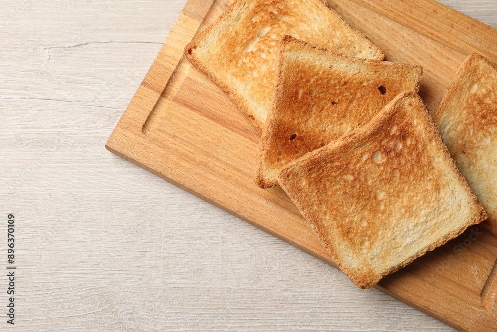 Slices of delicious toasted bread on wooden table, top view. Space for text Slices of delicious toasted bread on wooden table, top view. Space for text