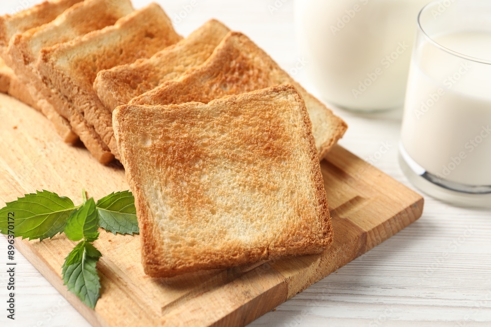 Delicious toasts with milk on white wooden table, closeup Delicious toasts with milk on white wooden table, closeup