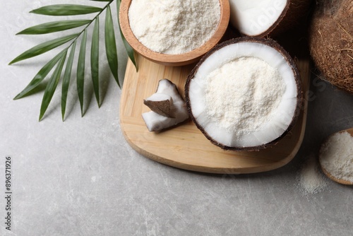 Organic coconut flour, fresh fruits and leaf on light grey table, flat lay. Space for text