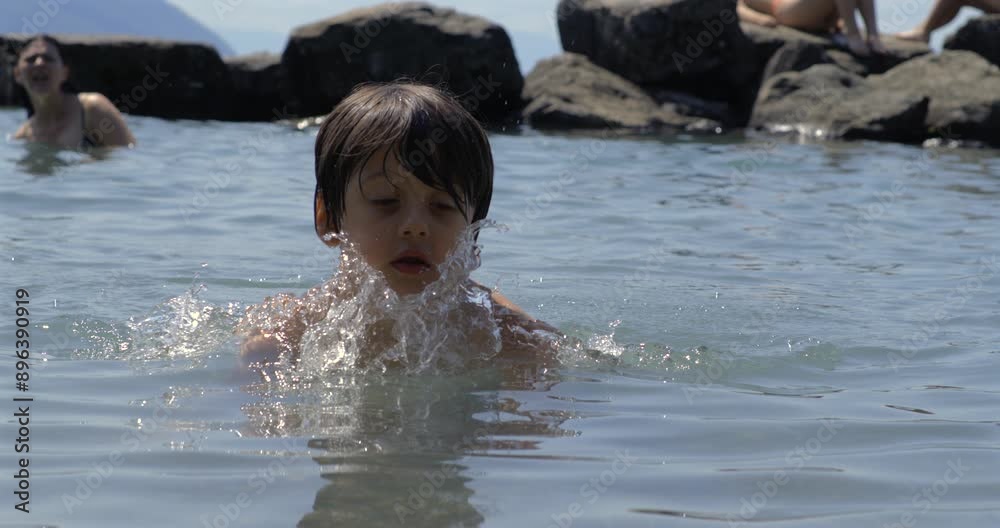 Child splashing water in slow motion at 800 fps, enjoying a fun swim in the lake with friends, capturing the essence of carefree summer days Child splashing water in slow motion at 800 fps, enjoying a fun swim in the lake with friends, capturing the essence of carefree summer days