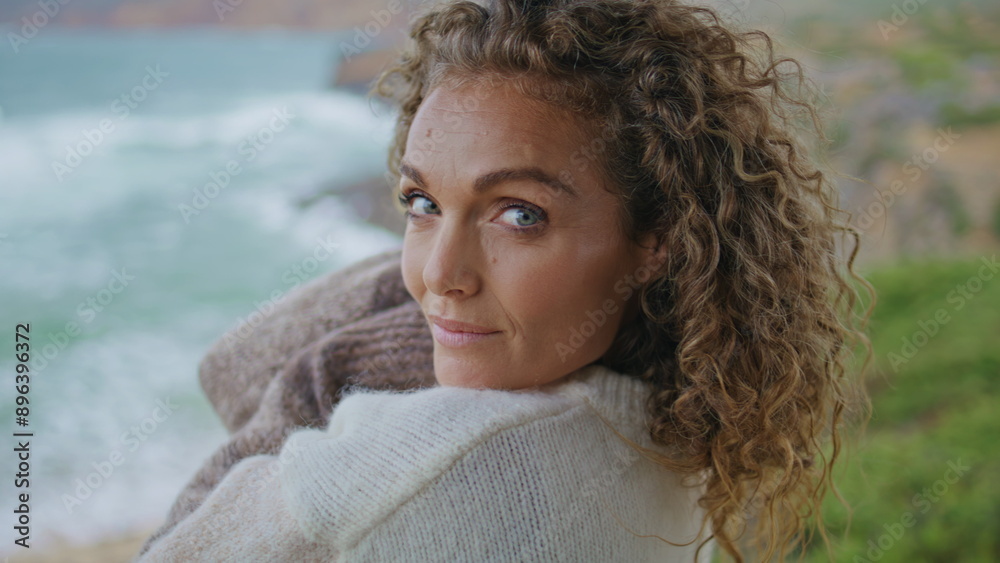 Attractive woman posing seashore at windy gloomy day close up. Portrait lady Attractive woman posing seashore at windy gloomy day close up. Portrait lady