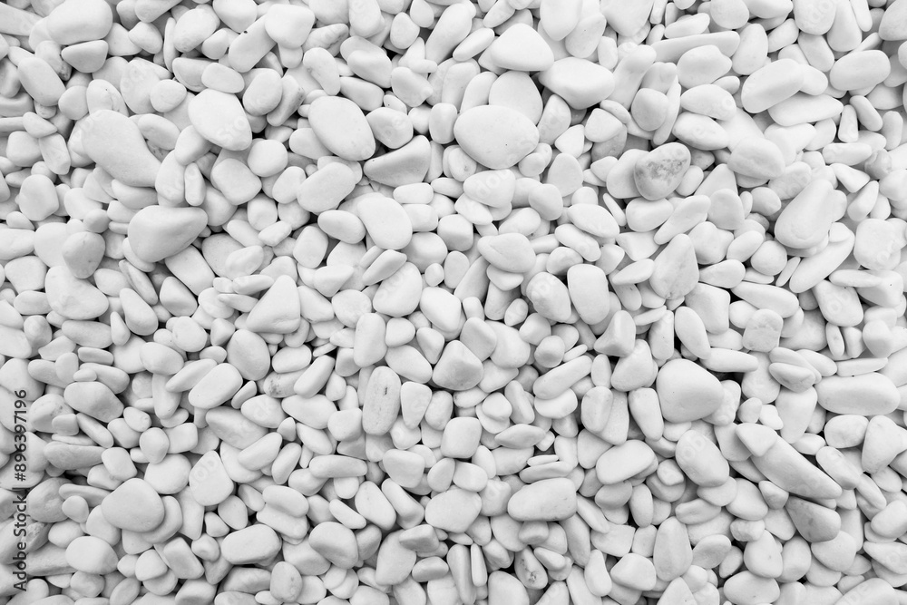 Close-up for oval pebbles of white gravel stones. White gravel as a decorative and architectural ingredient. Shot taken with natural lighting.