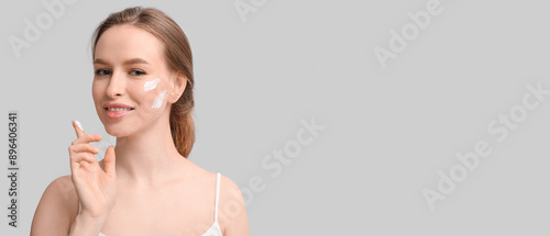 Young woman with cream poin...