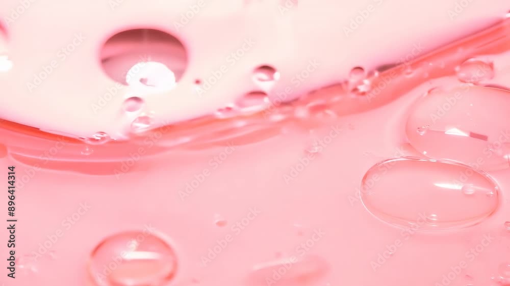 Pink gel with bubbles moves slowly, reflecting light