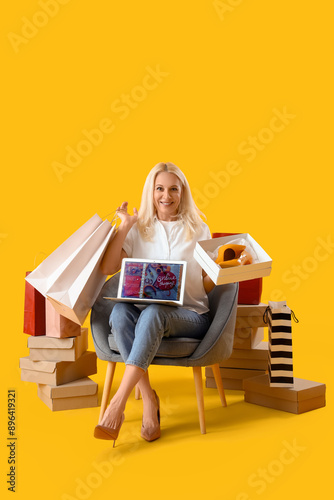 Mature woman with laptop an...