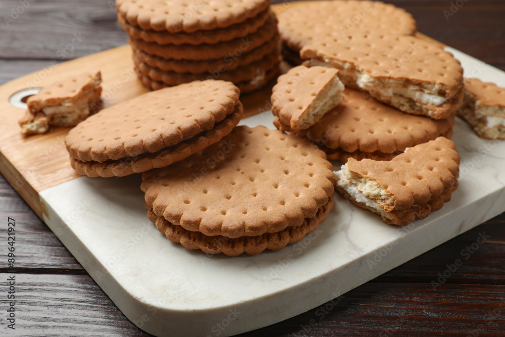 Tasty sandwich cookies on wooden table, closeup Tasty sandwich cookies on wooden table, closeup