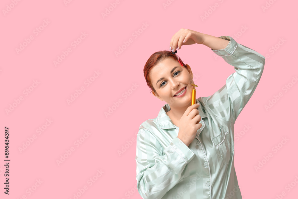Beautiful young woman using facial massage tools on pink background Beautiful young woman using facial massage tools on pink background