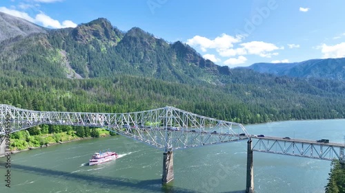 Aerial Tracking Shot of Bridge of the Gods and Riverboat in Columbia Gorge photo