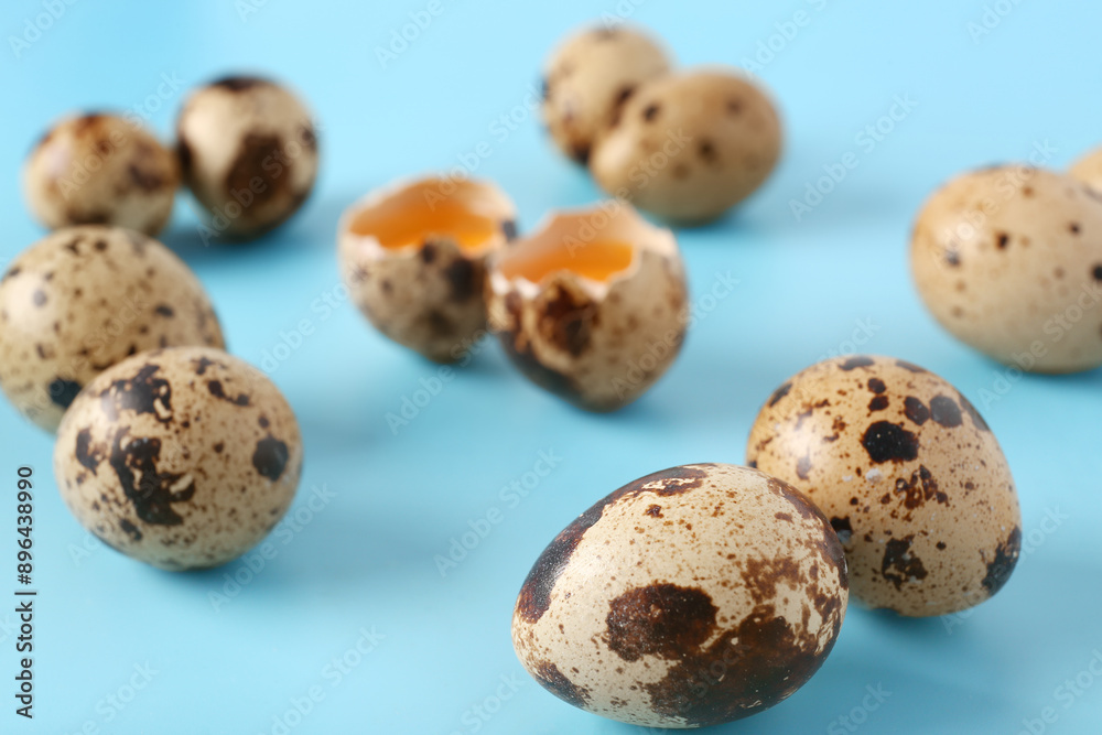 Composition with raw quail eggs on blue background, closeup Composition with raw quail eggs on blue background, closeup
