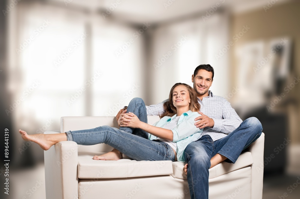 Happy romantic couple sitting on couch at room Happy romantic couple sitting on couch at room