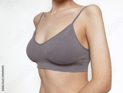 Obraz na plátně female breasts a woman in a sports bra  close up of female breast White backgro