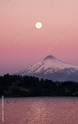 Sunset view by the lake and volcano photo