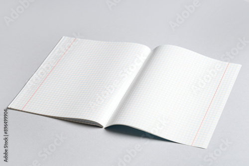 Open copybook with blank pages on grey background
