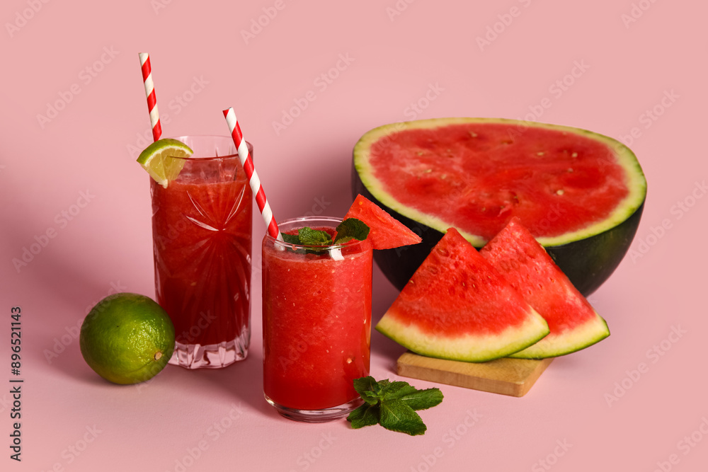 Glasses of fresh watermelon juice with lime and mint on pink background Glasses of fresh watermelon juice with lime and mint on pink background