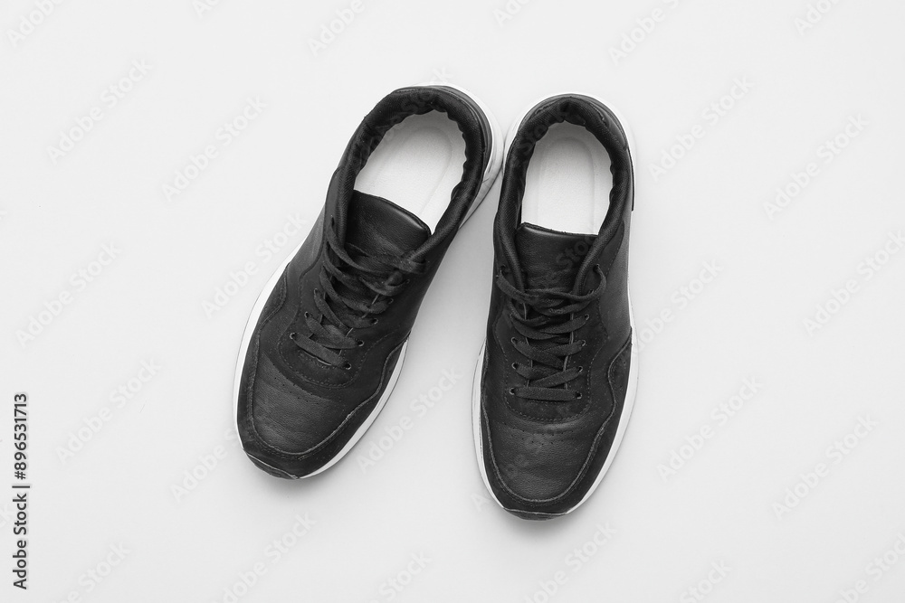 Stylish male black sneakers on grey background Stylish male black sneakers on grey background