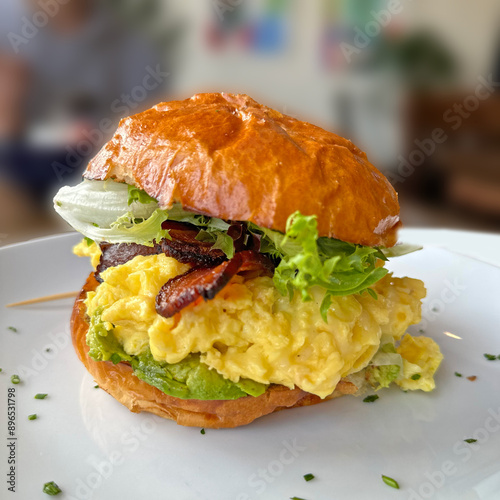 Breakfast Sandwich with scrambled eggs, bacon, lettuce and Golden Buttery Bun photo