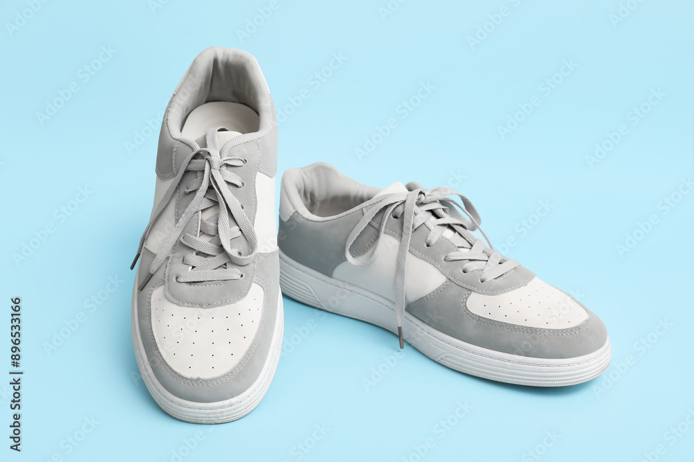Stylish male sneakers on blue background Stylish male sneakers on blue background