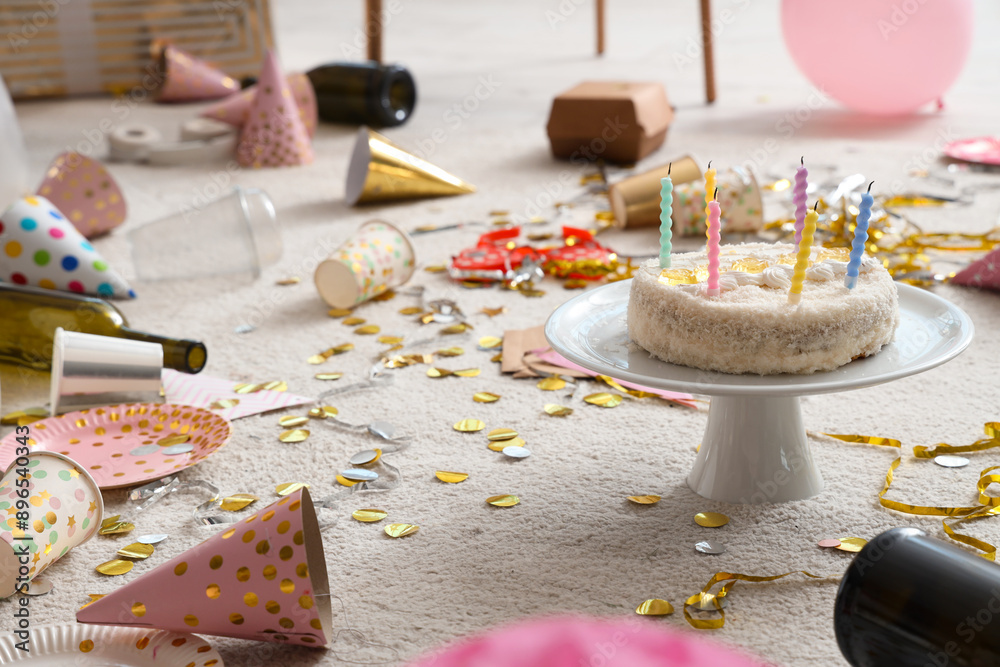 Fototapeta premium Birthday cake with confetti on carpet in living room after party, closeup
