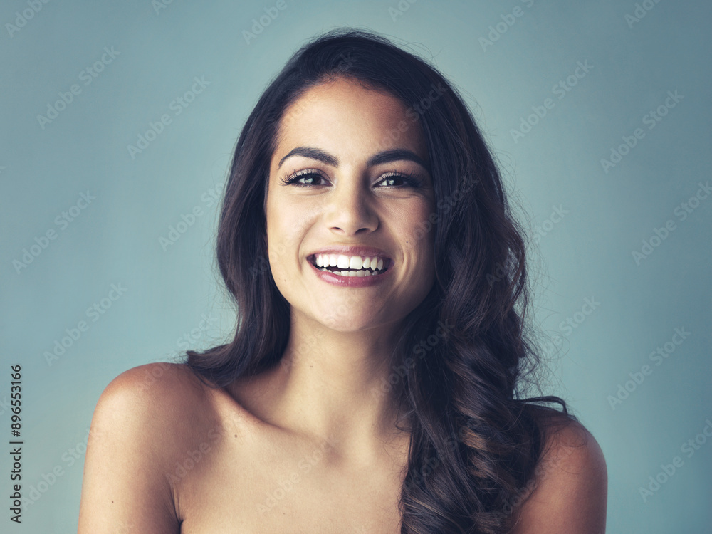 Satisfied, portrait or woman in studio for hair care, smooth or growth with collagen treatment with smile. Girl model, beauty or cosmetics for soft texture, healthy volume or shine by blue background Satisfied, portrait or woman in studio for hair care, smooth or growth with collagen treatment with smile. Girl model, beauty or cosmetics for soft texture, healthy volume or shine by blue background