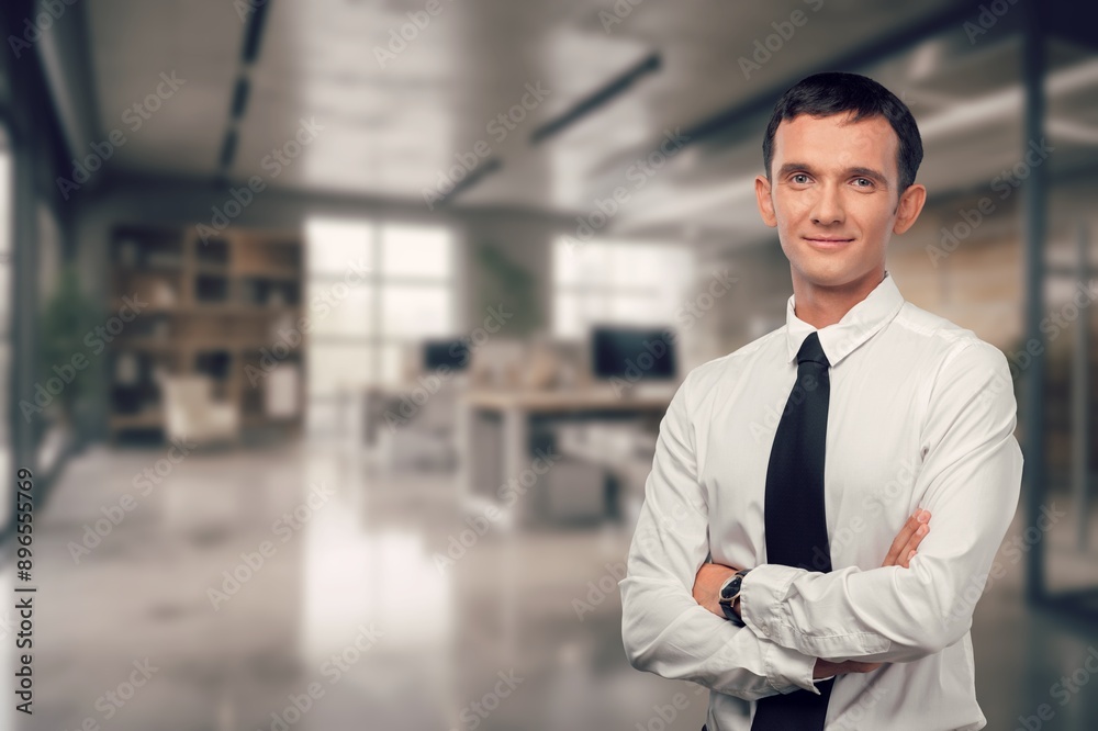 Happy confident business man standing in office Happy confident business man standing in office