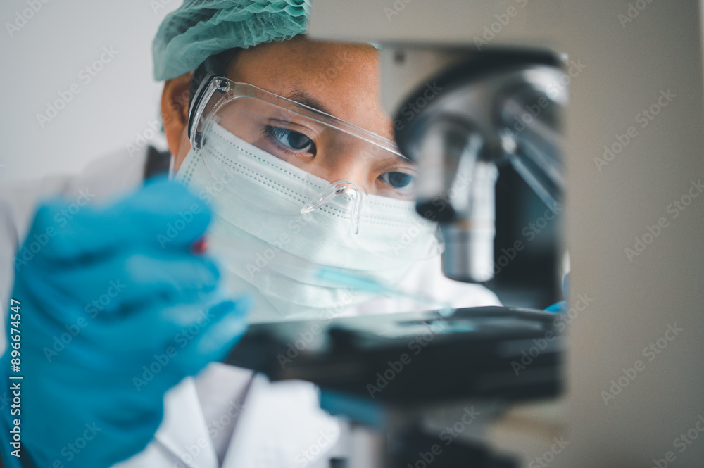 Female researchers are experimenting with pipette dropping a sample into a test tube in an experiment research in laboratory... Female researchers are experimenting with pipette dropping a sample into a test tube in an experiment research in laboratory...