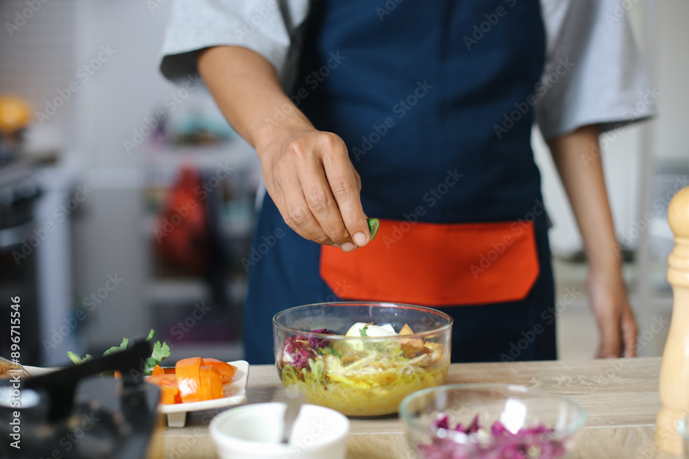 Man Wear Apron Making Homemade Chicken Soup With Squeezed Lime Man Wear Apron Making Homemade Chicken Soup With Squeezed Lime