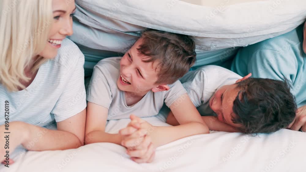 Happy, laughing and parents with children in the bed talking, bonding and having fun together. Smile, happiness and young mother and father relaxing with boy kids in bedroom of modern family home. Happy, laughing and parents with children in the bed talking, bonding and having fun together. Smile, happiness and young mother and father relaxing with boy kids in bedroom of modern family home.