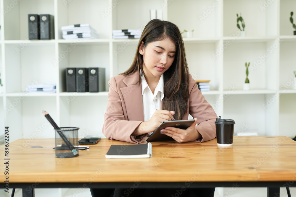 Asian business woman Use a laptop computer and work at the office ready. plan to analyze financial reports Asian business woman Use a laptop computer and work at the office ready. plan to analyze financial reports