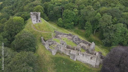 Drone fly up showcasing Okehampton Castle and surrounding woodland in Devon, UK photo