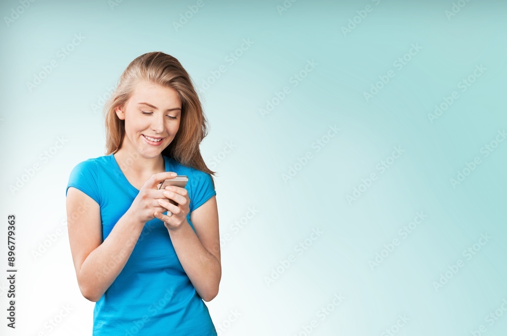 A young happy woman hold a smartphone A young happy woman hold a smartphone