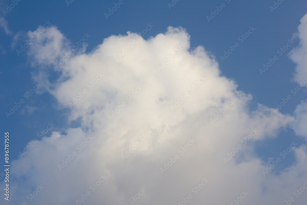 It's a blue sky with atmospheric puffy clouds. It's a blue sky with atmospheric puffy clouds.
