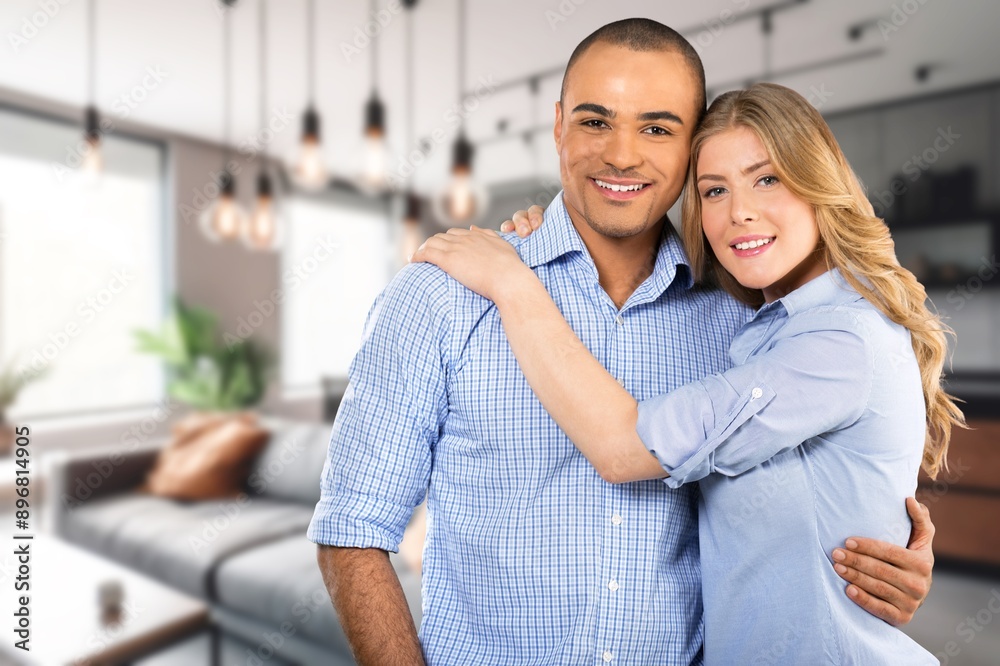 Portrait of happy family couple standing at home