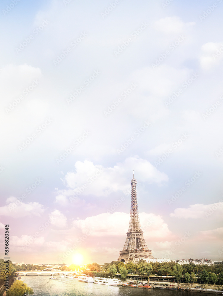 Fototapeta premium Eiffel tower sunset with clouds. Romantic sunset background. Old Monument with boats on Seine river in Paris, France