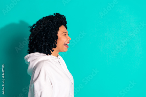 Side profile photo of young funny chevelure hair brunette lady looking curious laughing isolated on aquamarine color background