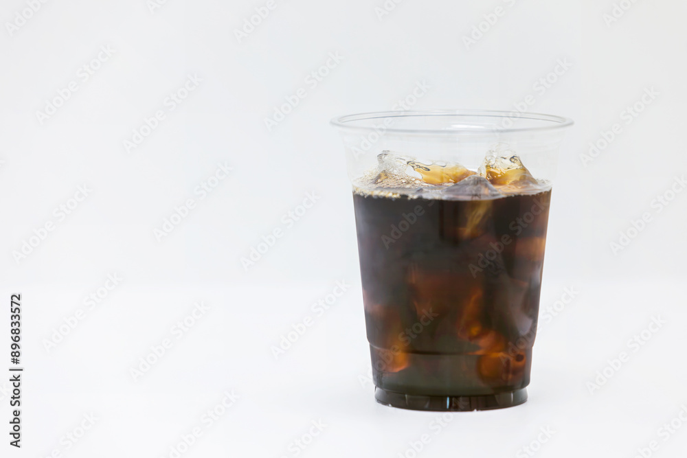 Iced Americano in a take-out plastic cup. white background Iced Americano in a take-out plastic cup. white background