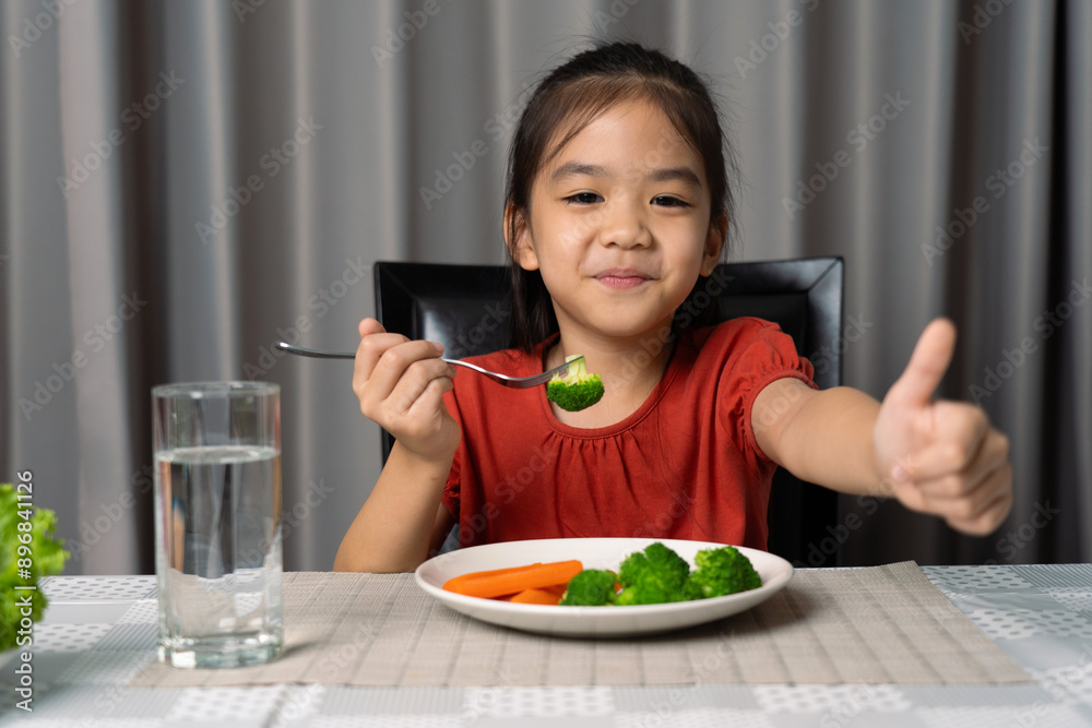Cute little girl showing thumb showing eating healthy vegetables. Cute little girl showing thumb showing eating healthy vegetables.