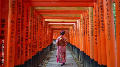 4k Slow motion video, Asian woman in traditional Japanese kimono at Fushimi Inari Shrine in Kyoto Japan.