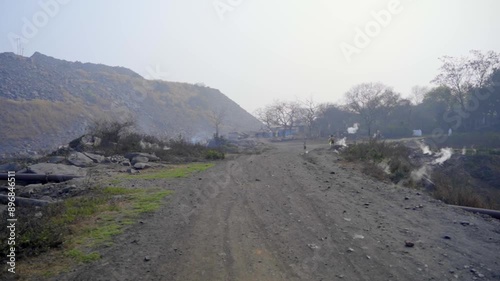 Smoke coming from the underground coal field fire in local communities of Jharia in eastern India photo